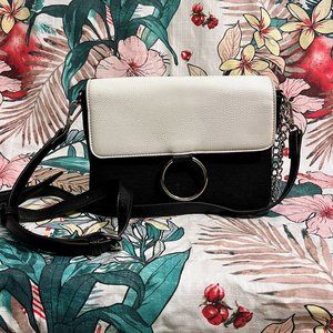 Carlos by Carlos Santana Black and White Crossbody bag with adjustable strap.